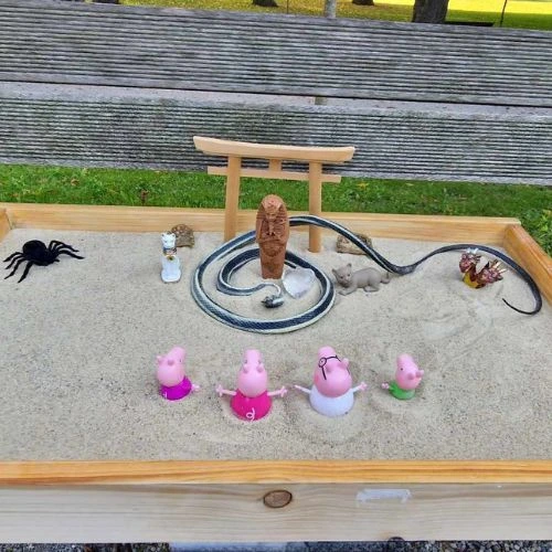 sand play therapy tray with figurines