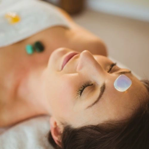 crystal therapy crystals on womans face